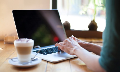 a woman working at a laptop